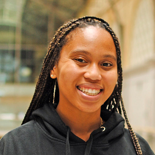 Headshot of Deven Okry, Foodwise's Operations Coordinator, taken in the San Francisco Ferry Building Grand Hall