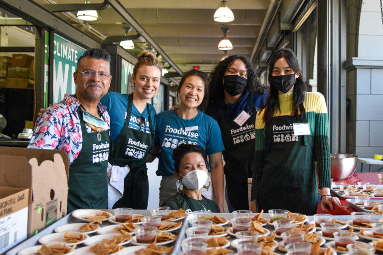 Foodwise staff and volunteers posing with Chef Rick Martinez at the Foodwise Kitchen